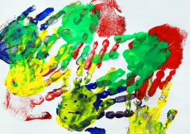 Multicoloured painted hand prints 